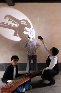 three women performing a shadow puppet play