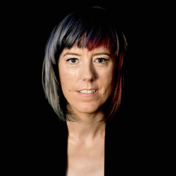 white woman facing forward with chin length hair and bangs